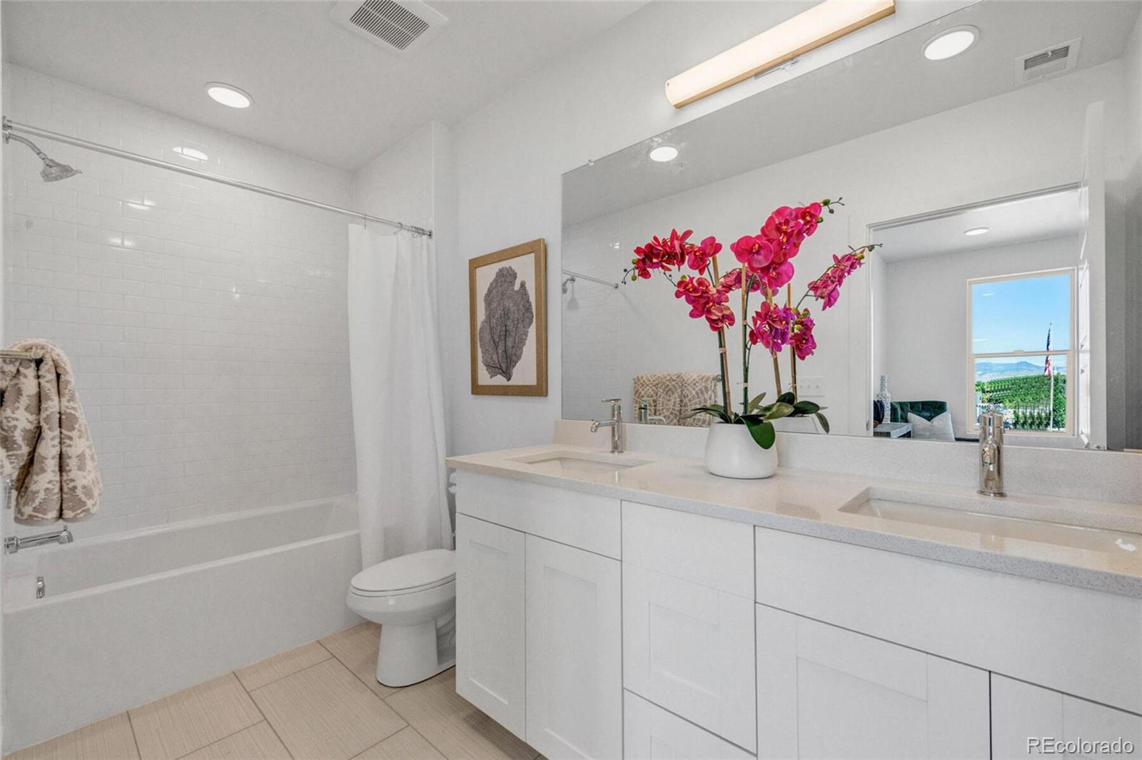 2899 West 52nd Avenue, Unit 301 Denver, CO 80221 - Photo 11 of 16 a bathroom with a granite countertop sink mirror and toilet