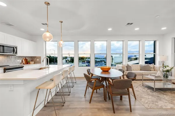 a large kitchen with a table and chairs