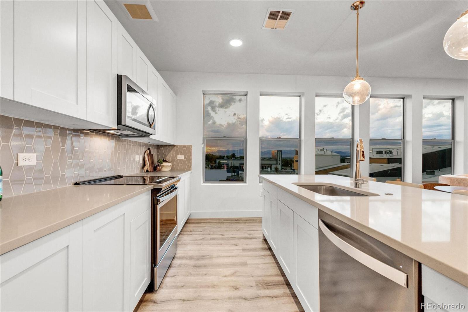 2899 West 52nd Avenue, Unit 301 Denver, CO 80221 - Photo 16 of 16 a kitchen with a stove and a sink
