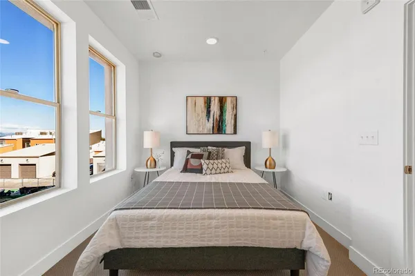 a bedroom with a bed and a large mirror