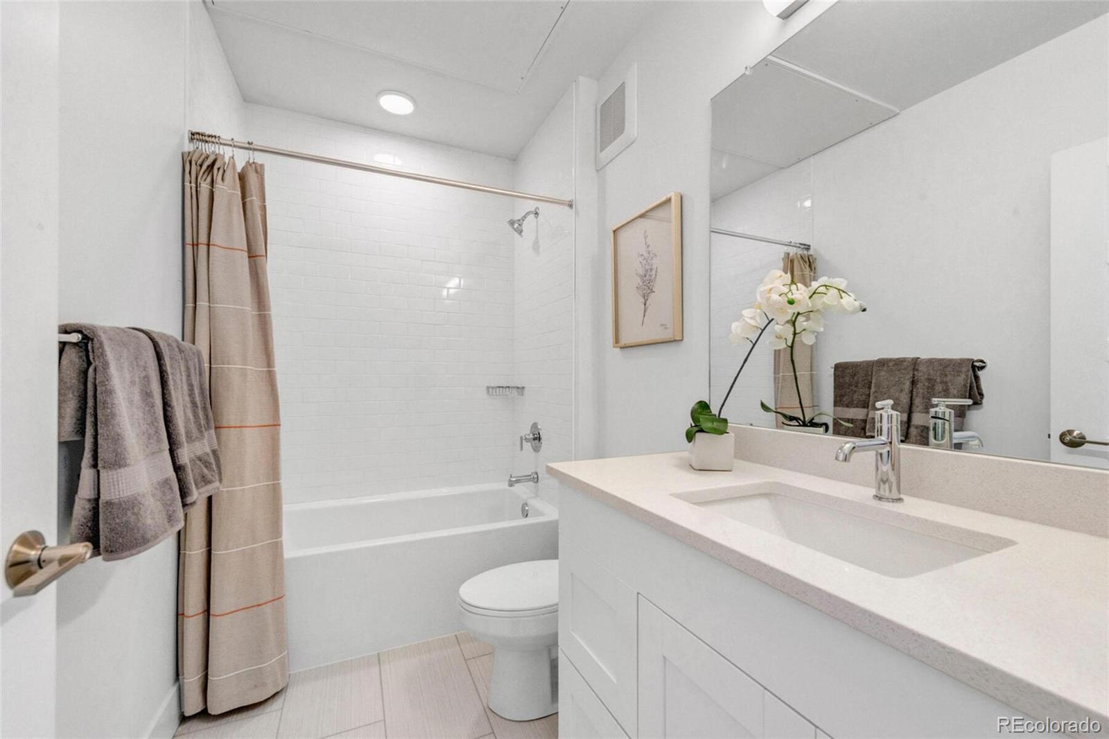 2899 West 52nd Avenue, Unit 301 Denver, CO 80221 - Photo 9 of 16 a bathroom with a sink toilet and shower
