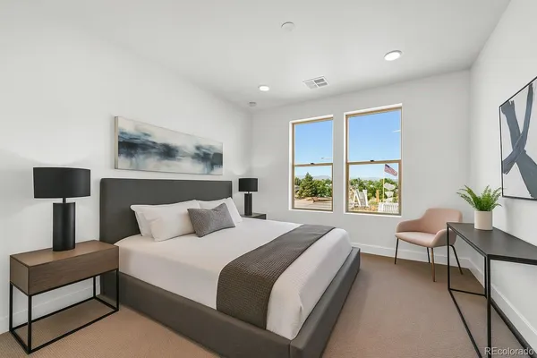 a bedroom with a bed and a lamp