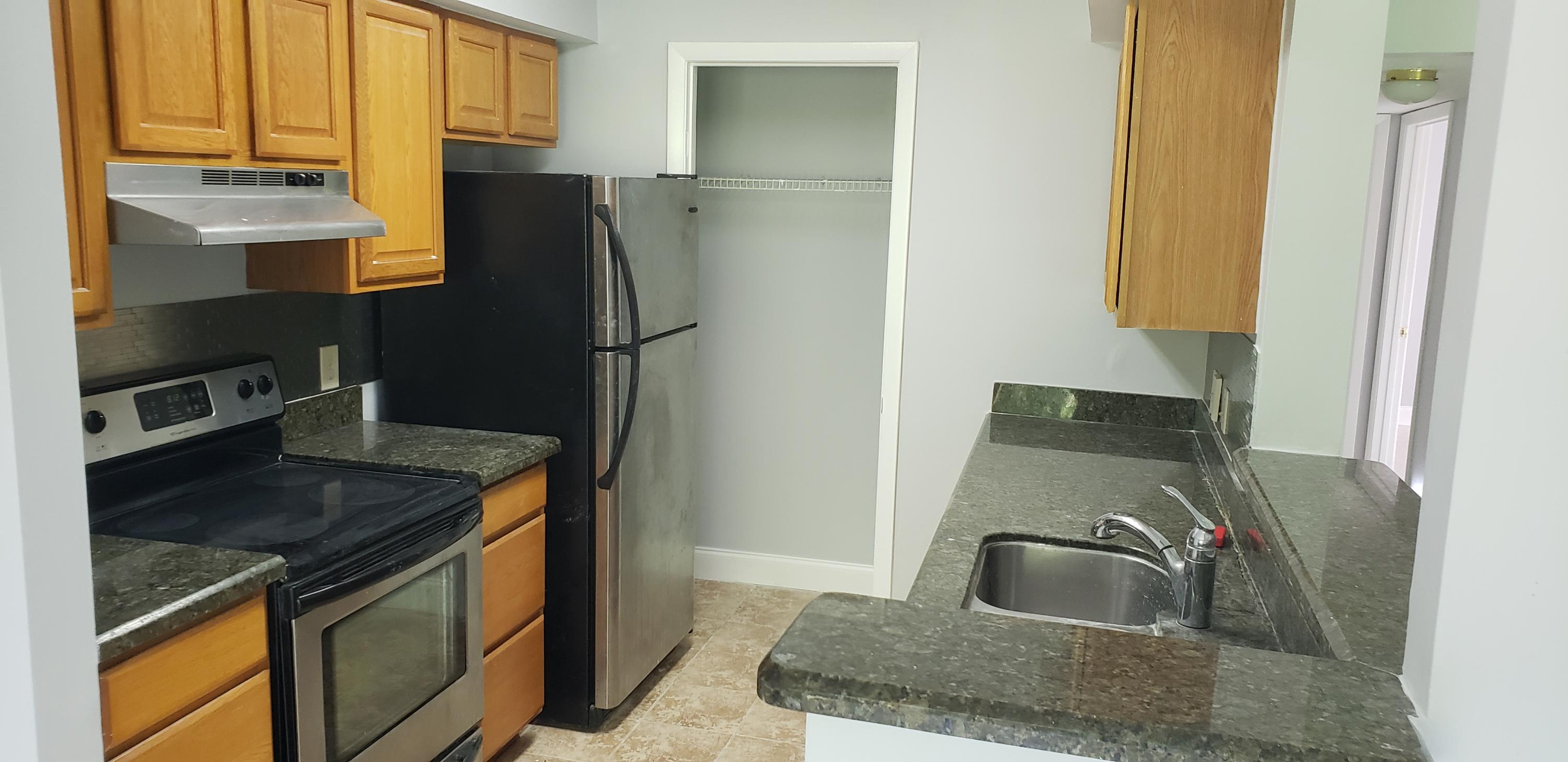 a kitchen with a refrigerator sink and stove