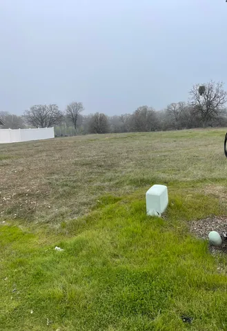 a view of a lake with a yard