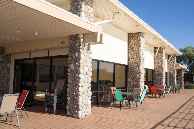 a view of a dinning tables and chairs in patio of the house