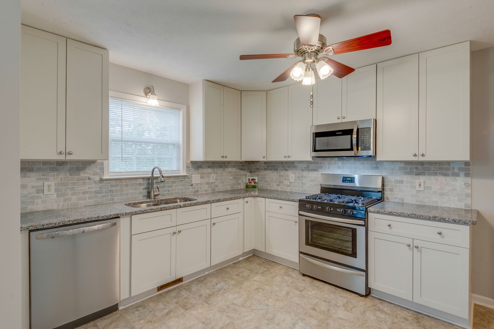 265 Eastside Road Burns, TN 37029 - Photo 11 of 41 a kitchen with white cabinets stainless steel appliances and sink