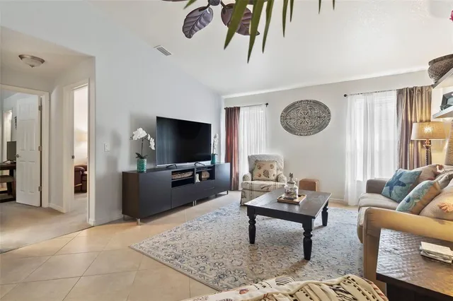 a living room with furniture a rug and a flat screen tv