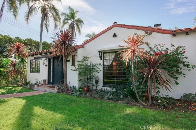 a view of a house with a palm trees