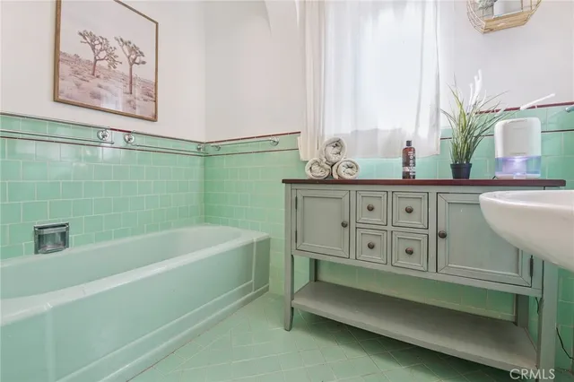 a bathroom with a bathtub and a sink