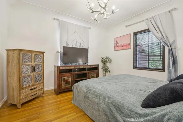 a bedroom with a bed and a flat screen tv