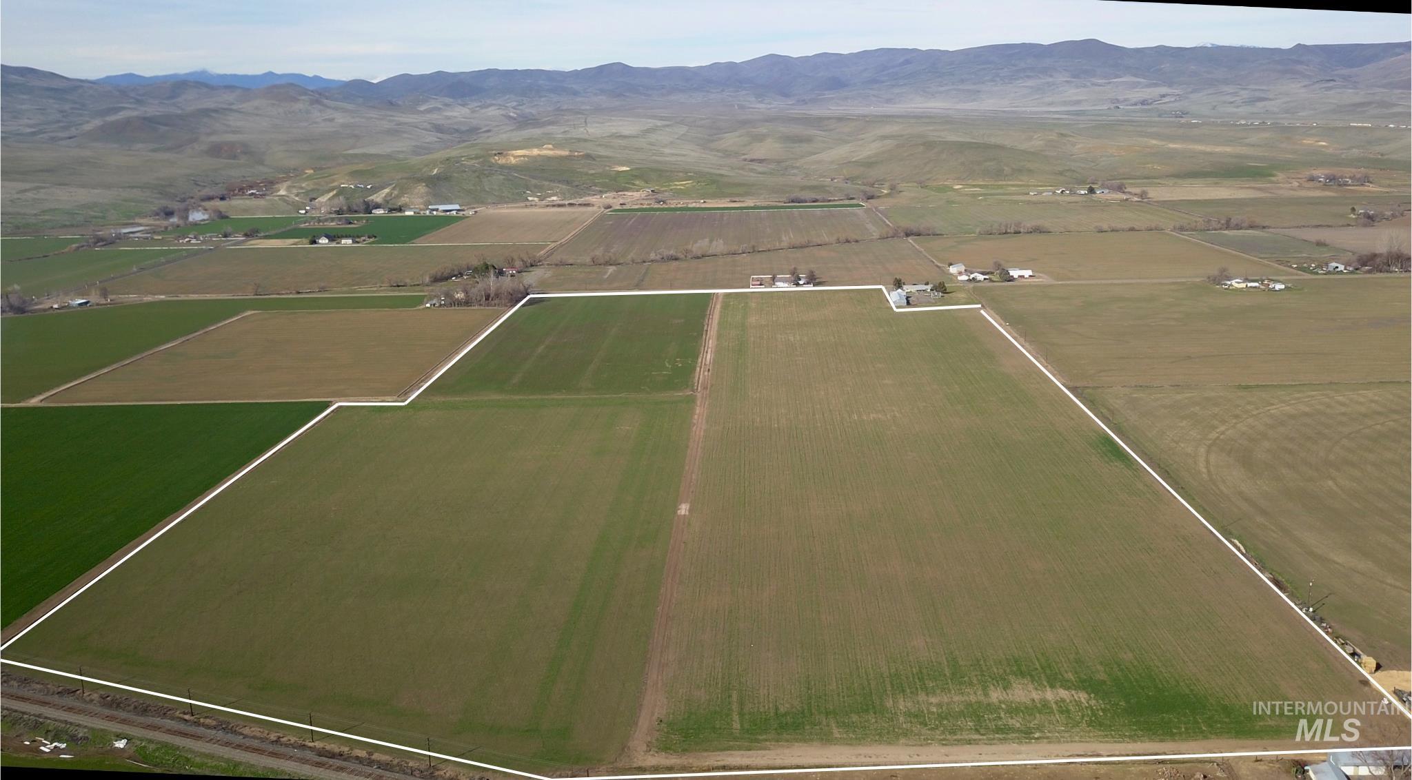 Tbd Olds Ferry Road Weiser, ID 83672 - Photo 2 of 10 Aerial view of property and surrounding area featuring a mountainous background and rural landscape
