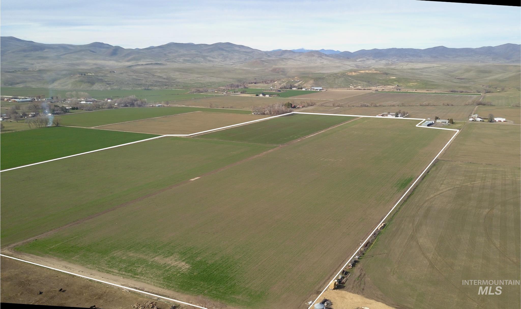 Tbd Olds Ferry Road Weiser, ID 83672 - Photo 3 of 10 Aerial view of property and surrounding area with rural landscape, a mountain backdrop, and farmland