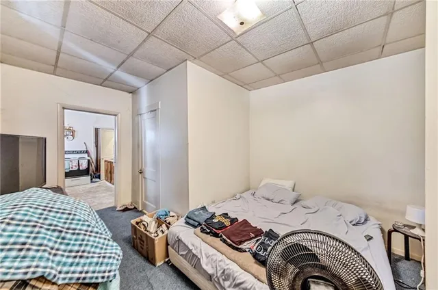 a bedroom with a bed and dresser