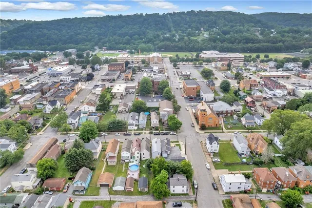 an aerial view of residential houses with outdoor space and river