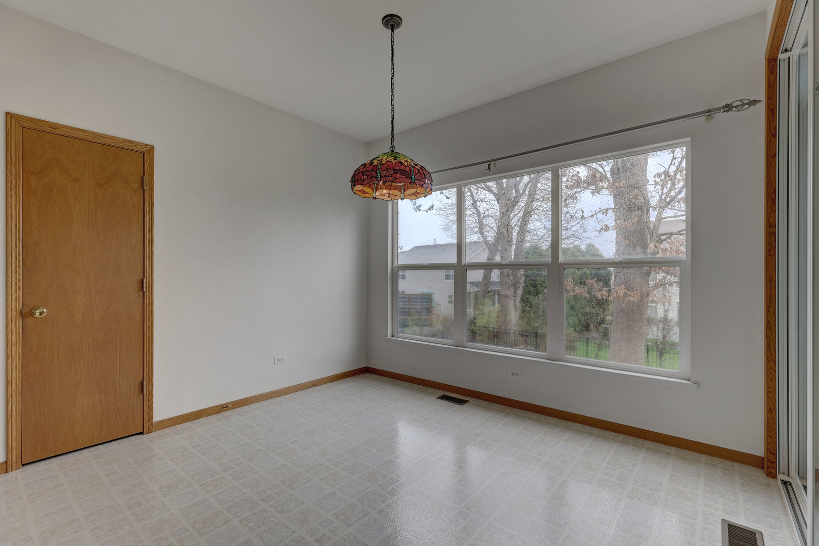 3206 Chestnut Drive McHenry, IL 60051 - Photo 11 of 30 a view of an empty room with windows and chandelier