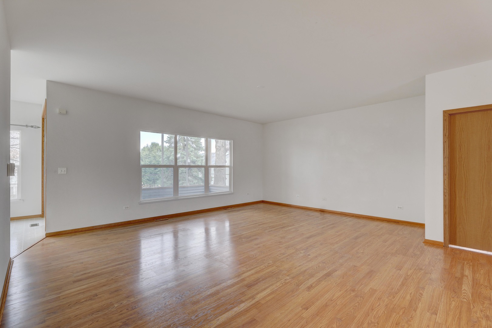 3206 Chestnut Drive McHenry, IL 60051 - Photo 12 of 30 a view of an empty room with wooden floor and a window