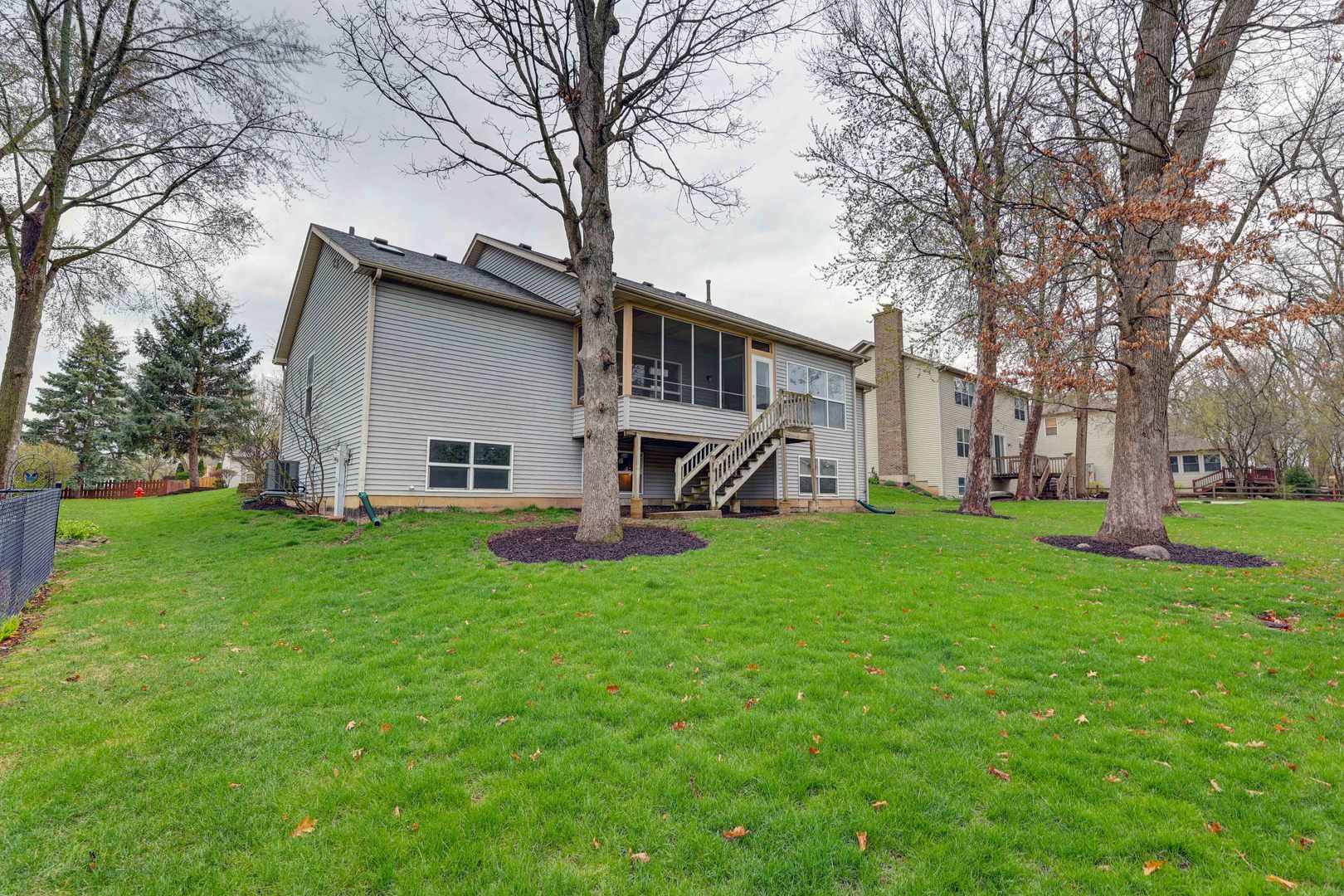 3206 Chestnut Drive McHenry, IL 60051 - Photo 30 of 30 a view of a house with a big yard next to a large tree