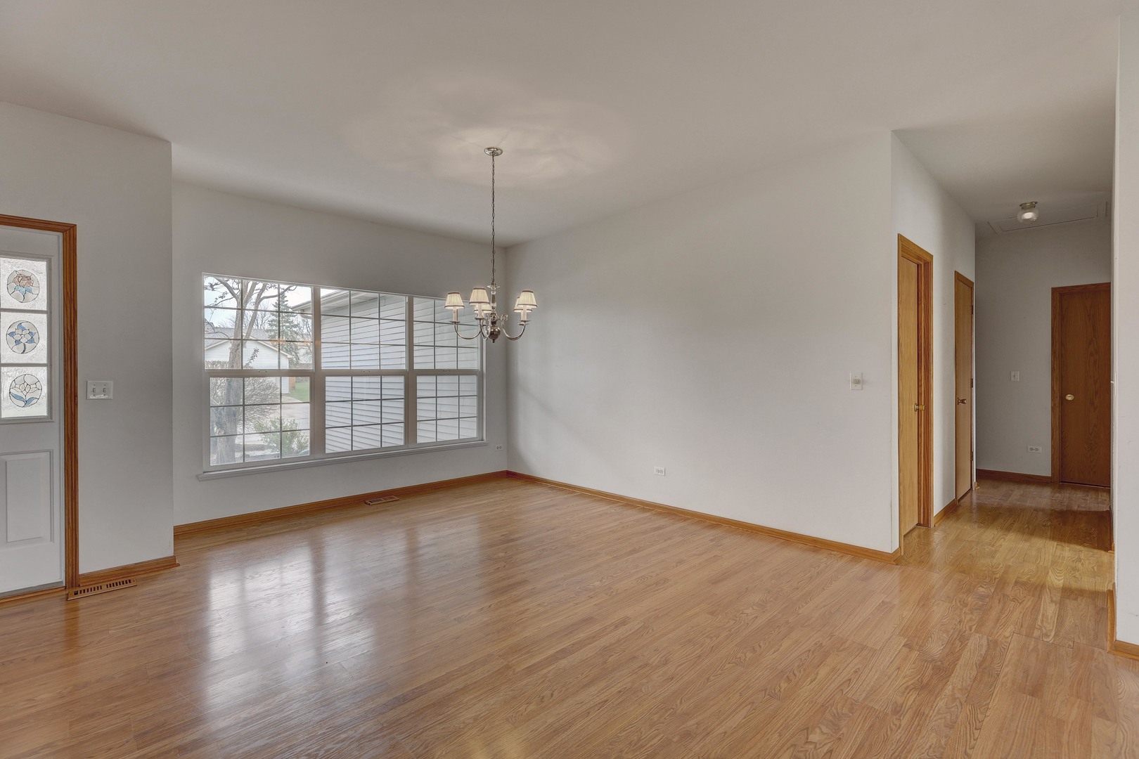 3206 Chestnut Drive McHenry, IL 60051 - Photo 4 of 30 an empty room with wooden floor and windows