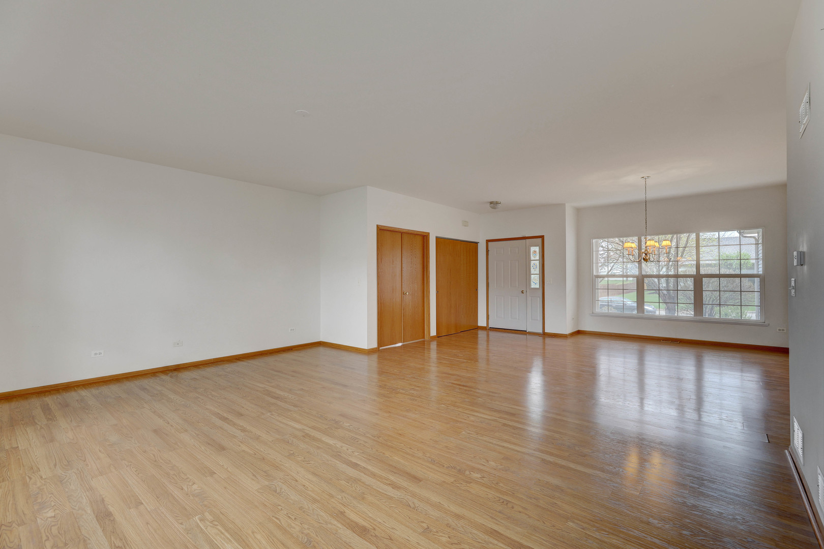 3206 Chestnut Drive McHenry, IL 60051 - Photo 7 of 30 a view of an empty room with wooden floor and window