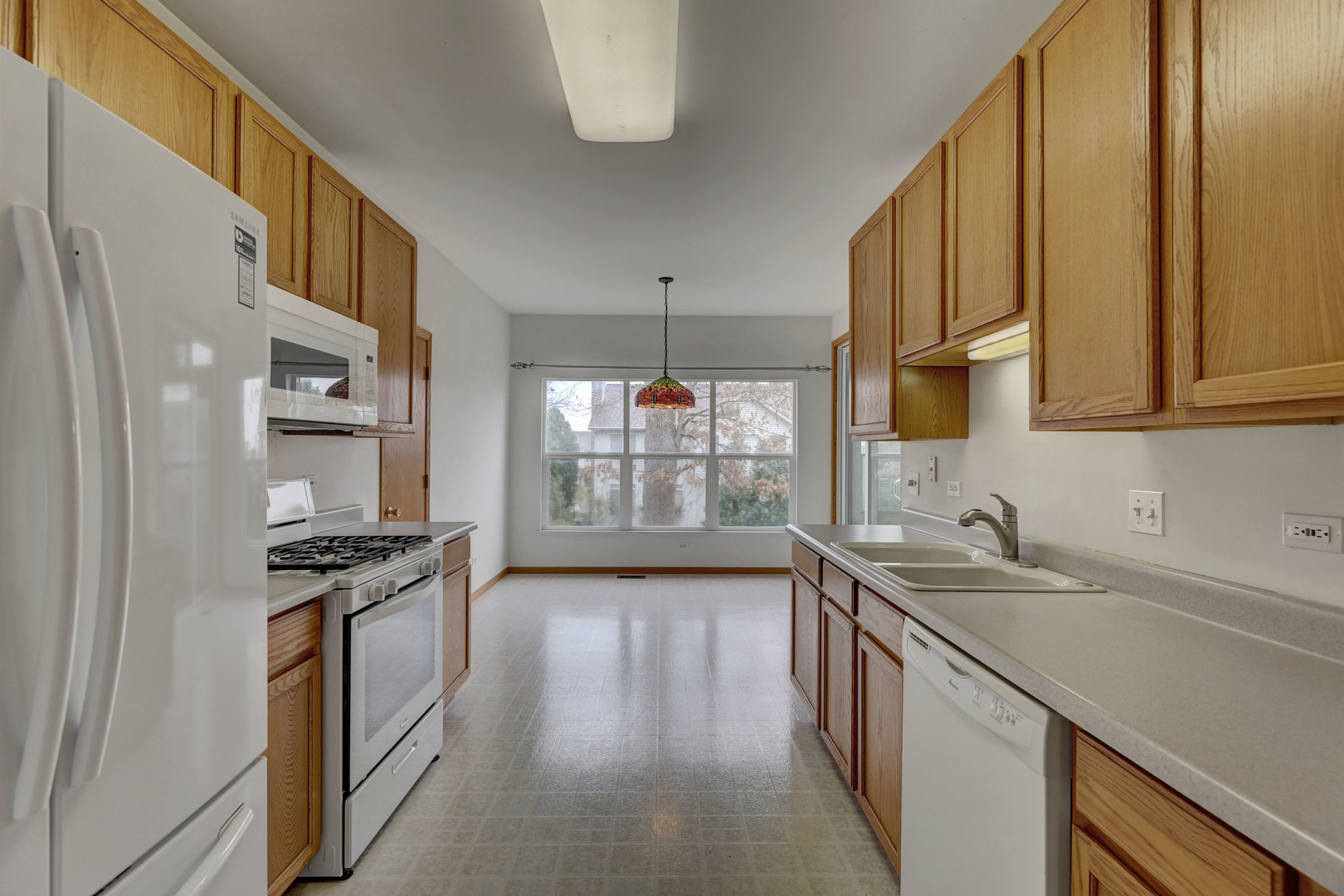 3206 Chestnut Drive McHenry, IL 60051 - Photo 10 of 30 a kitchen with stainless steel appliances granite countertop a sink stove and refrigerator