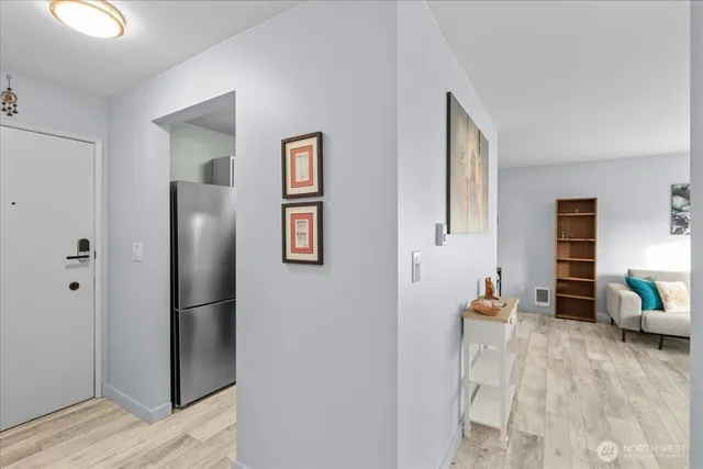 a kitchen with stainless steel appliances granite countertop a refrigerator a stove and a sink