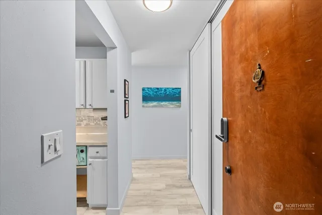a kitchen with stainless steel appliances granite countertop a sink and a stove with white countertops