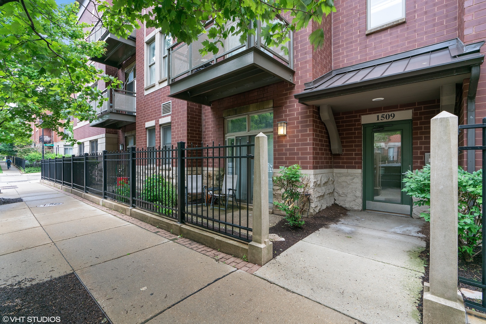 a view of a brick house with a large window and plants