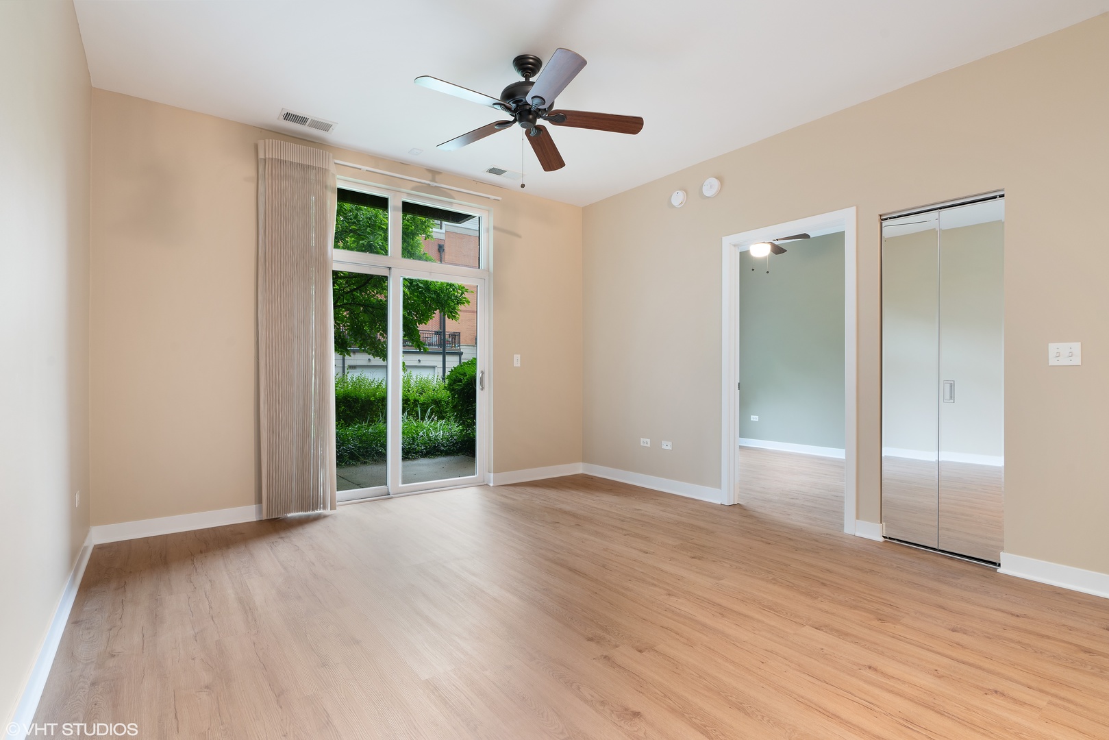 1509 South Halsted Street, Unit 211 Chicago, IL 60607 - Photo 3 of 13 a view of an empty room with a window and wooden floor