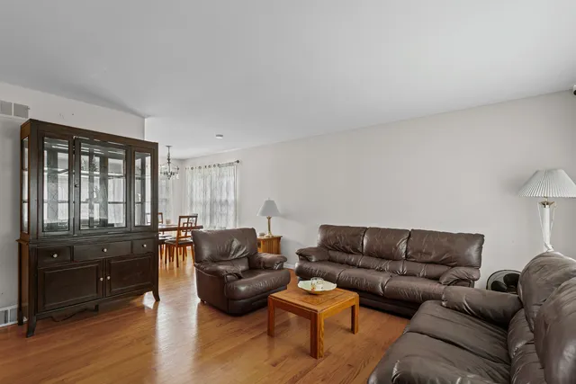a living room with furniture window and wooden floor