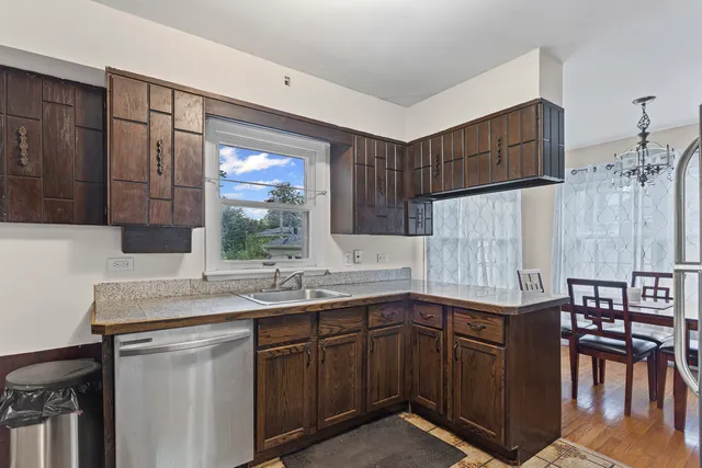 a kitchen with a sink cabinets and window