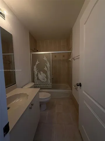 a bathroom with a shower toilet and sink