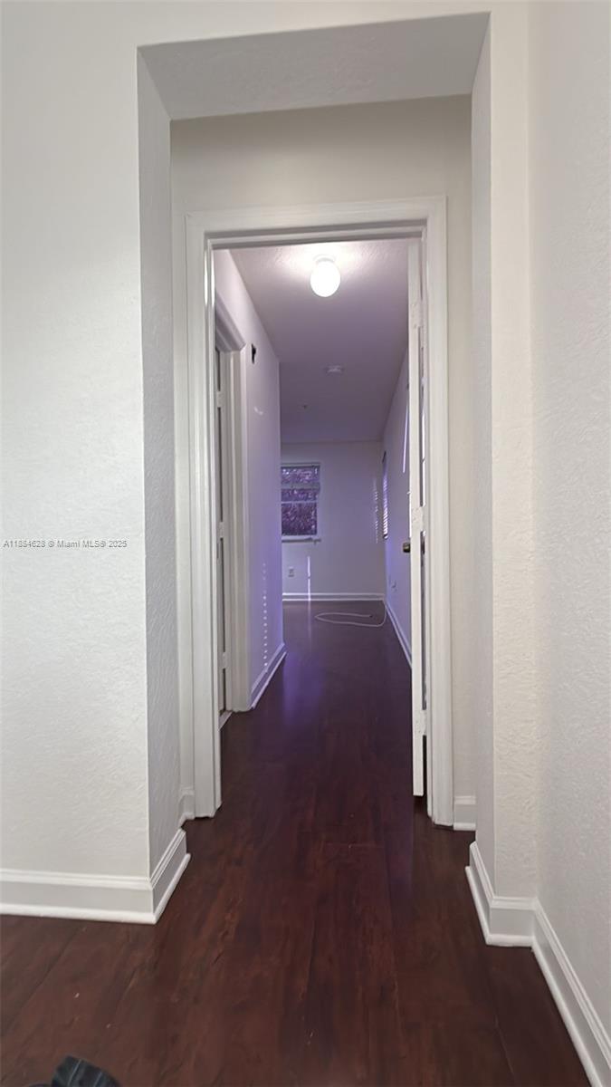 17640 Northwest 73rd Avenue, Unit 20019 Hialeah, FL 33015 - Photo 7 of 8 a view of a hallway with wooden floor
