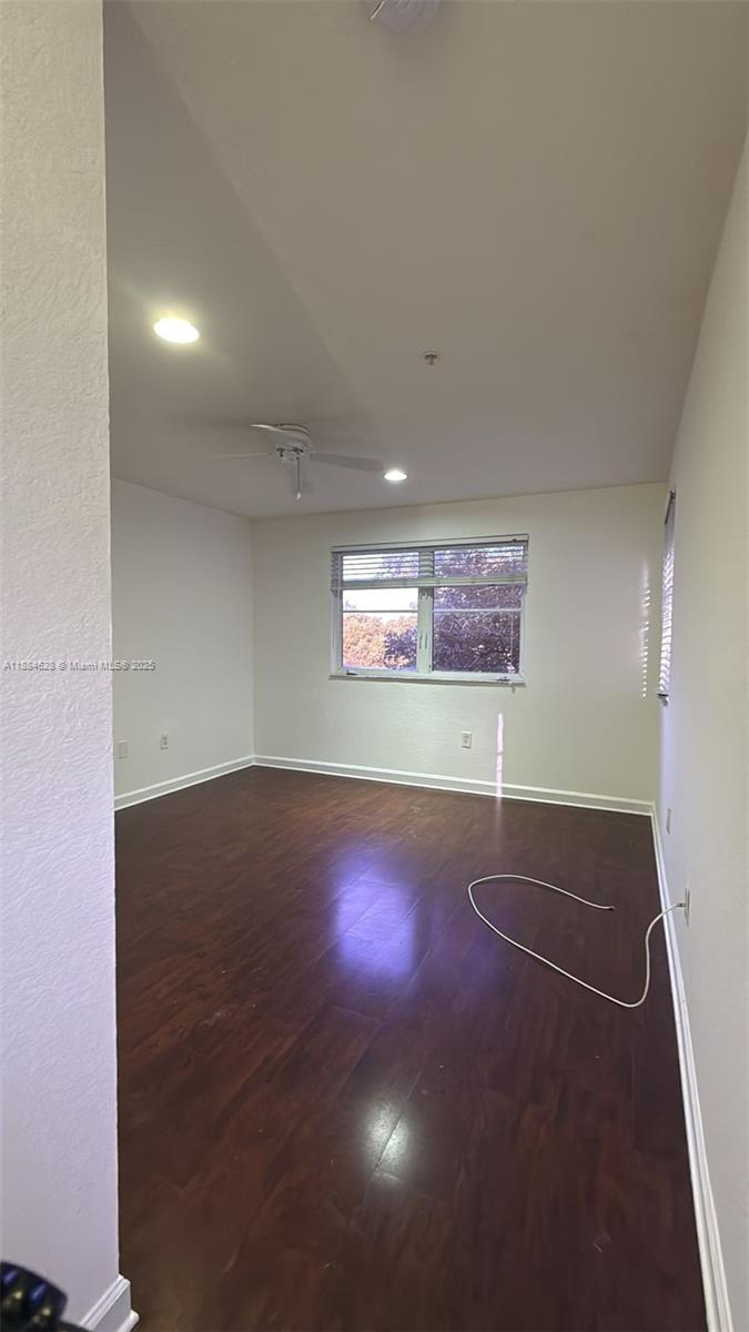 17640 Northwest 73rd Avenue, Unit 20019 Hialeah, FL 33015 - Photo 8 of 8 an empty room with a space and windows