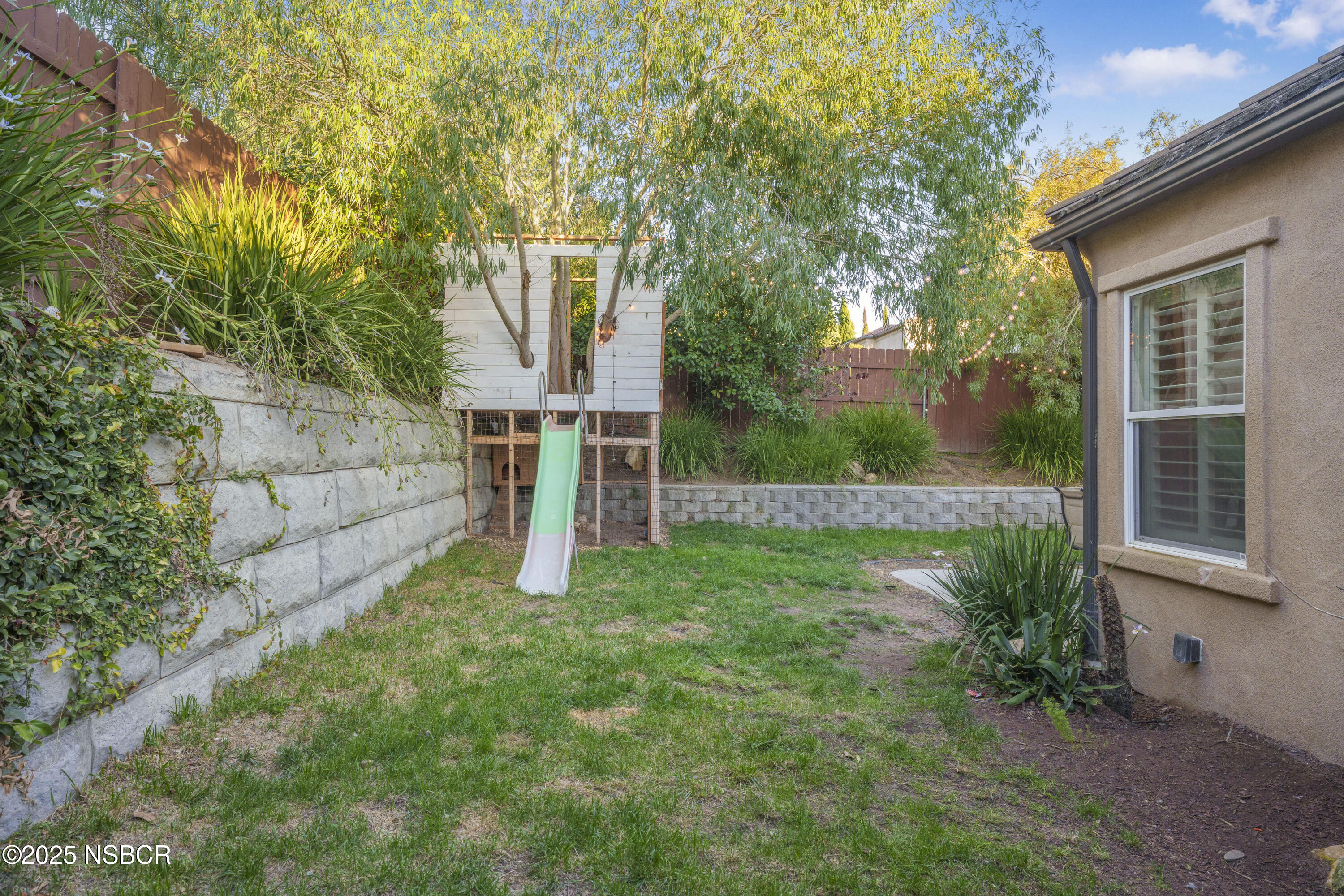 758 Voyager Road Lompoc, CA 93436 - Photo 39 of 46 a view of a backyard with a garden and entertaining space