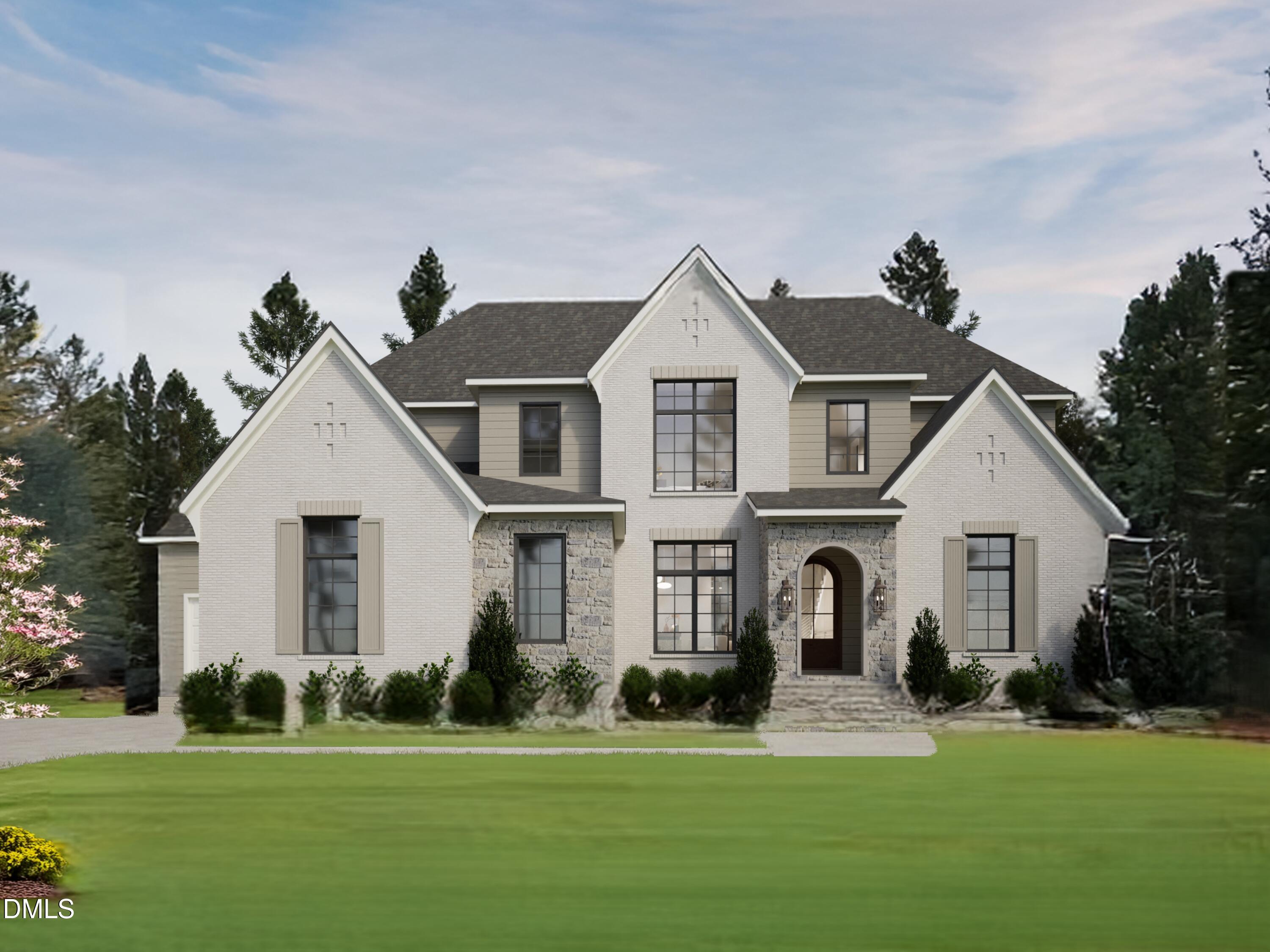 a front view of a house with a garden and yard
