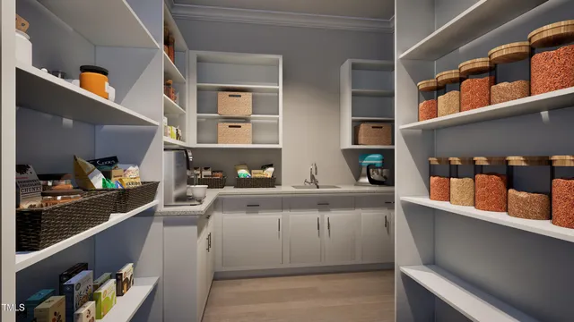 a dining room with furniture a chandelier and kitchen view
