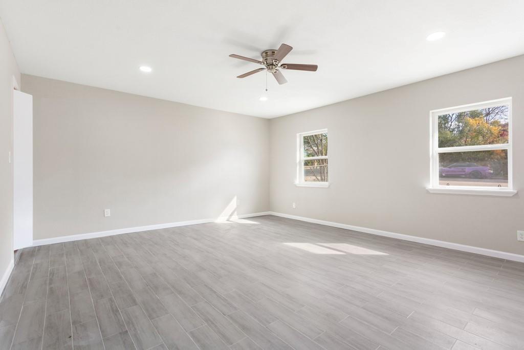 9604 Crown Ridge Road Austin, TX 78753 - Photo 19 of 24 A spacious room offers ample natural light and clean, modern finishes, creating an inviting atmosphere.