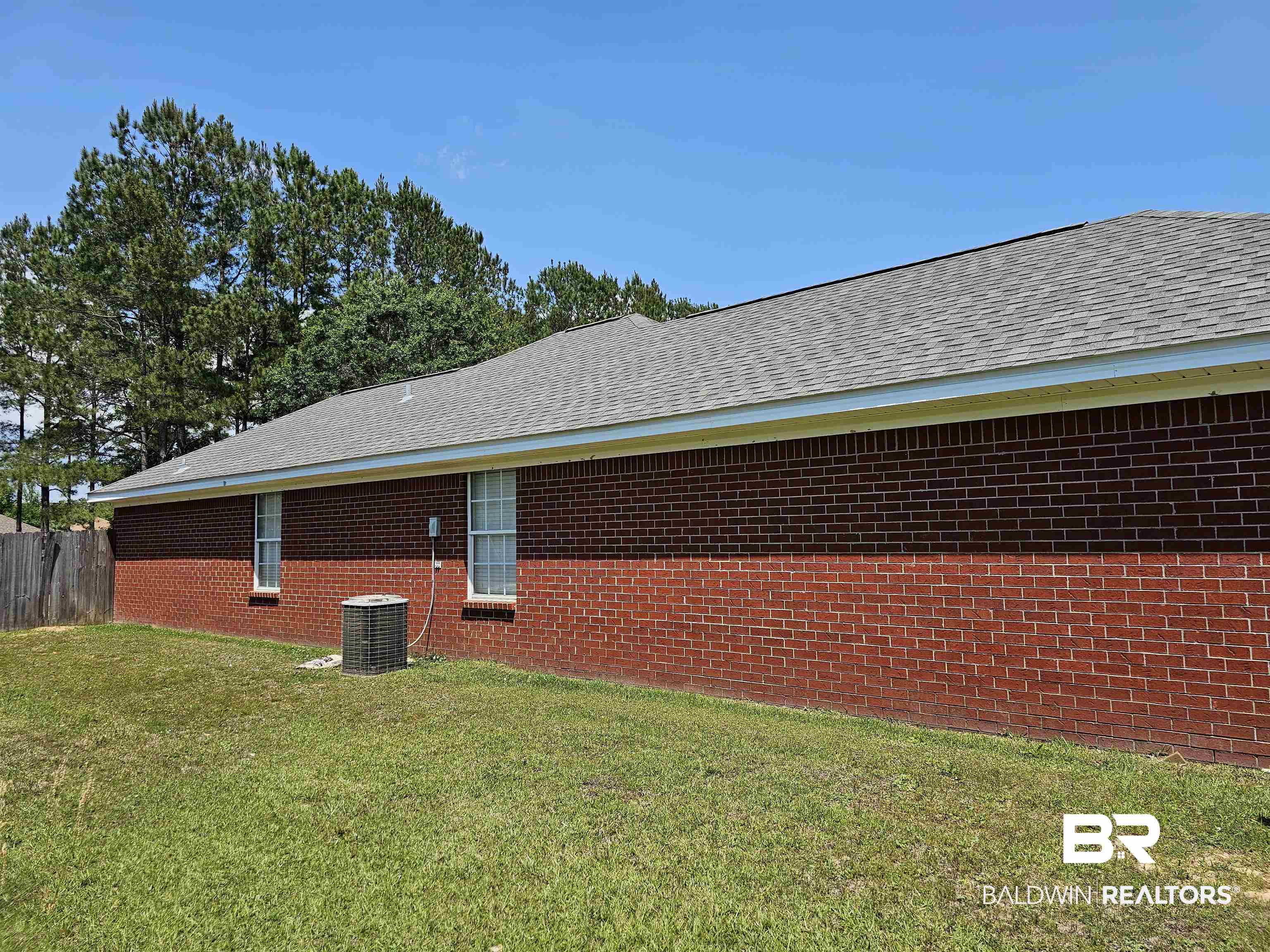 431 Hamilton Boulevard Foley, AL 36535 - Photo 29 of 30 Left side of brick house and both guest bedroom windows.