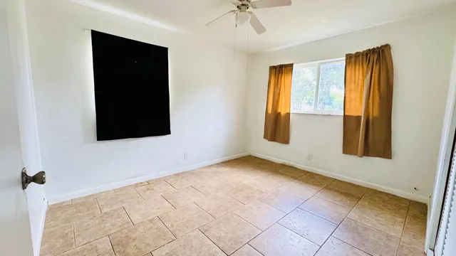 a view of a house with backyard and a tree