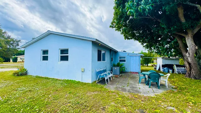 a view of a patio with table and chairs and potted plants