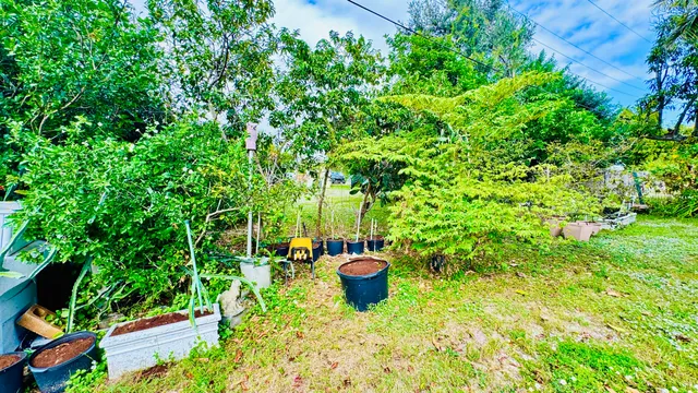a view of yellow house with swimming pool