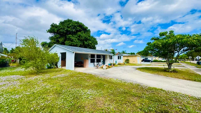 a view of a house with swimming pool and sitting area