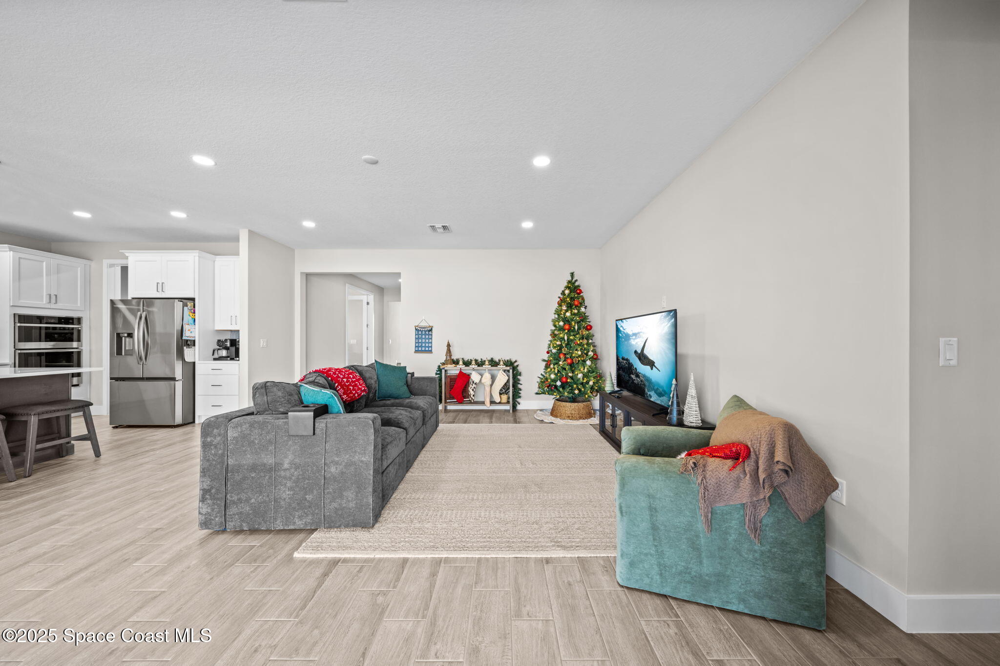 2846 Silverlefe Lane Melbourne, FL 32940 - Photo 11 of 58 a living room with furniture and a flat screen tv