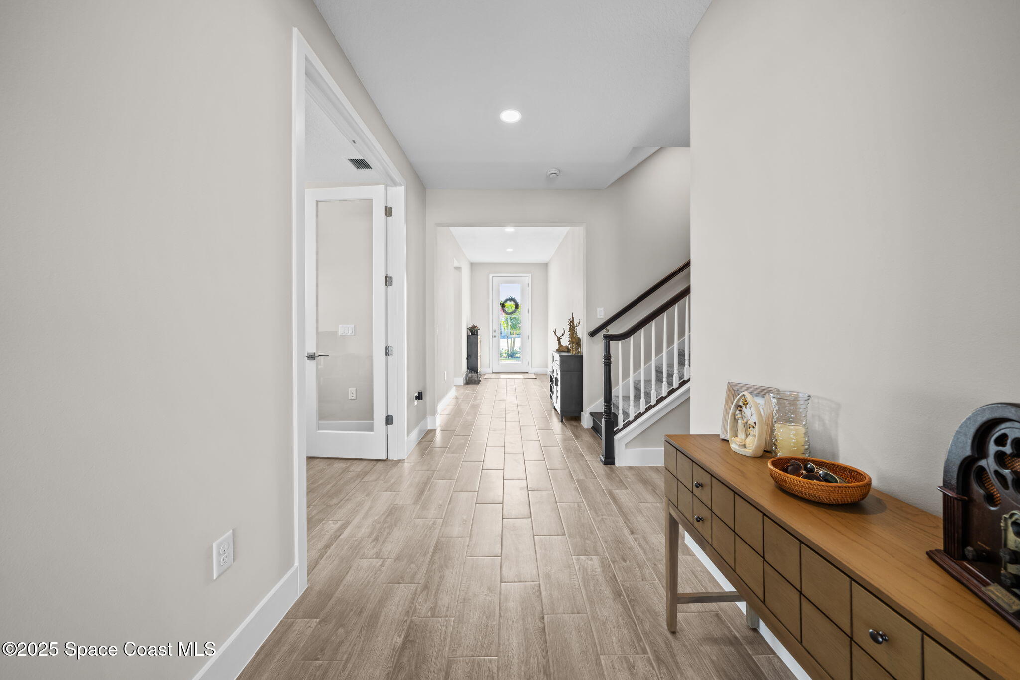 2846 Silverlefe Lane Melbourne, FL 32940 - Photo 15 of 58 a hallway with wooden floor windows