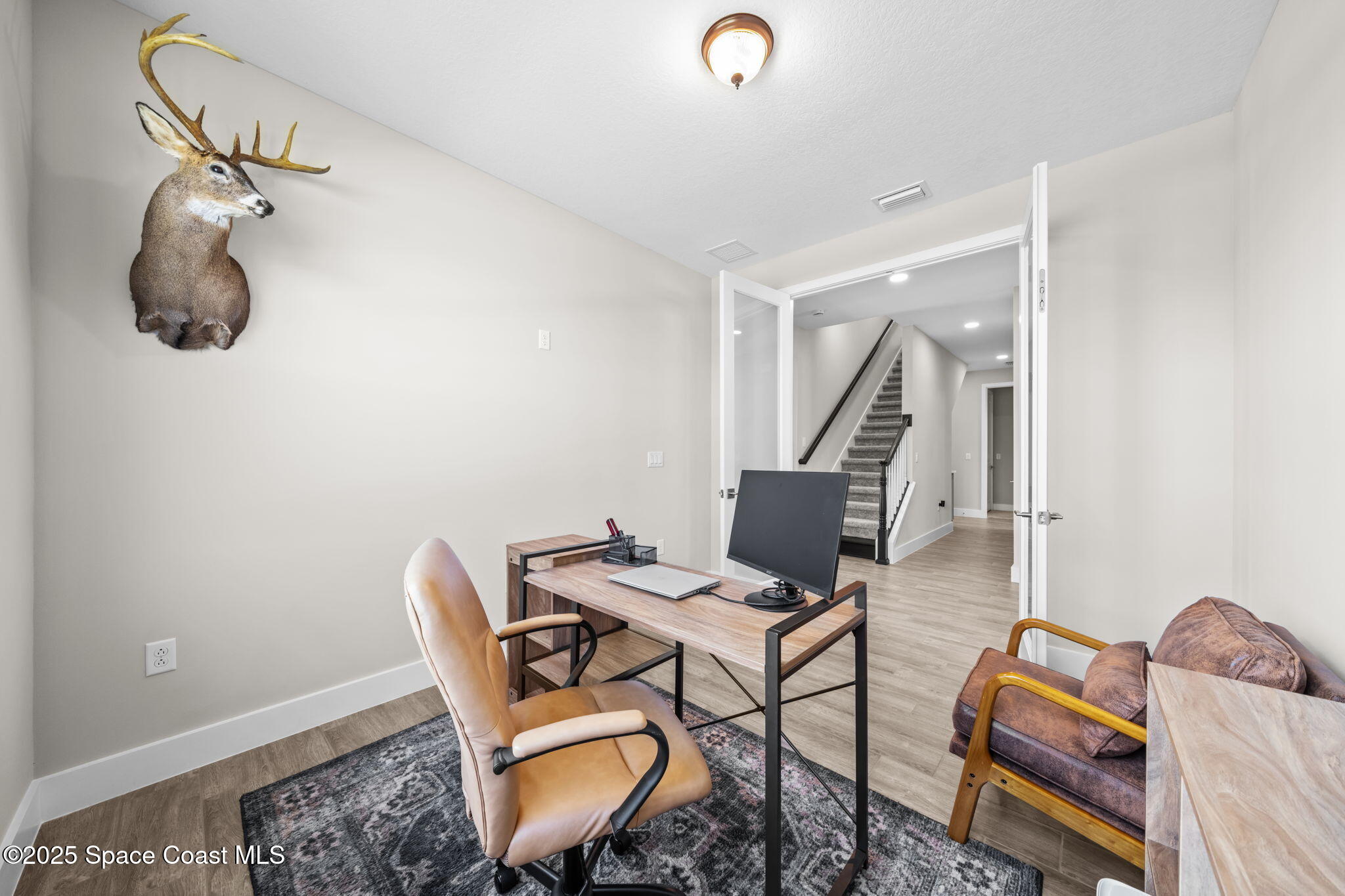 2846 Silverlefe Lane Melbourne, FL 32940 - Photo 18 of 58 a workspace with furniture and wooden floor