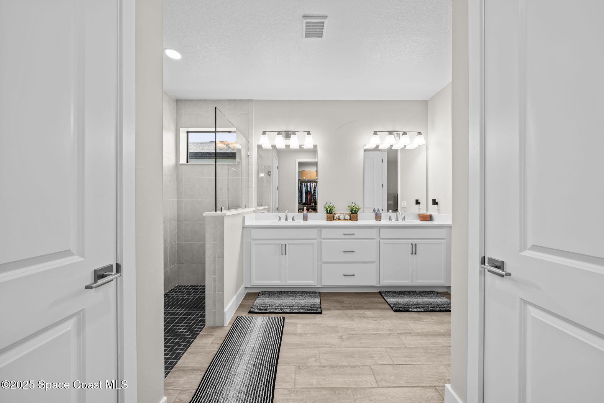 2846 Silverlefe Lane Melbourne, FL 32940 - Photo 23 of 58 a bathroom with a double vanity sink mirror and shower
