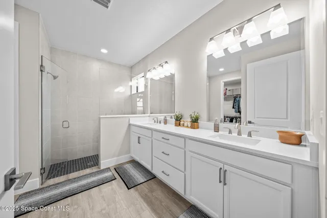 a spacious bathroom with a double vanity sink mirror and