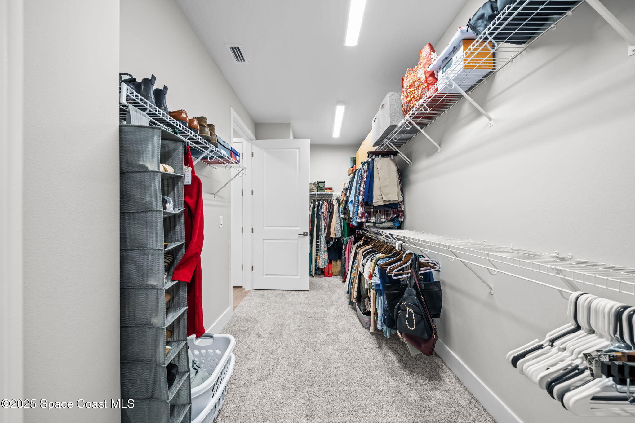 2846 Silverlefe Lane Melbourne, FL 32940 - Photo 25 of 58 a view of walk in closet with clothes and shoes