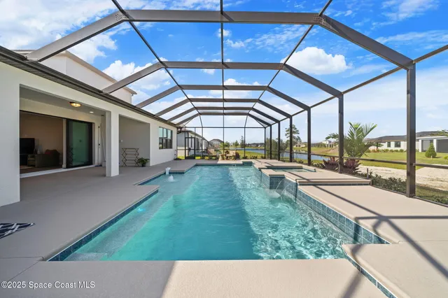a aerial view of a swimming pool with outdoor seating