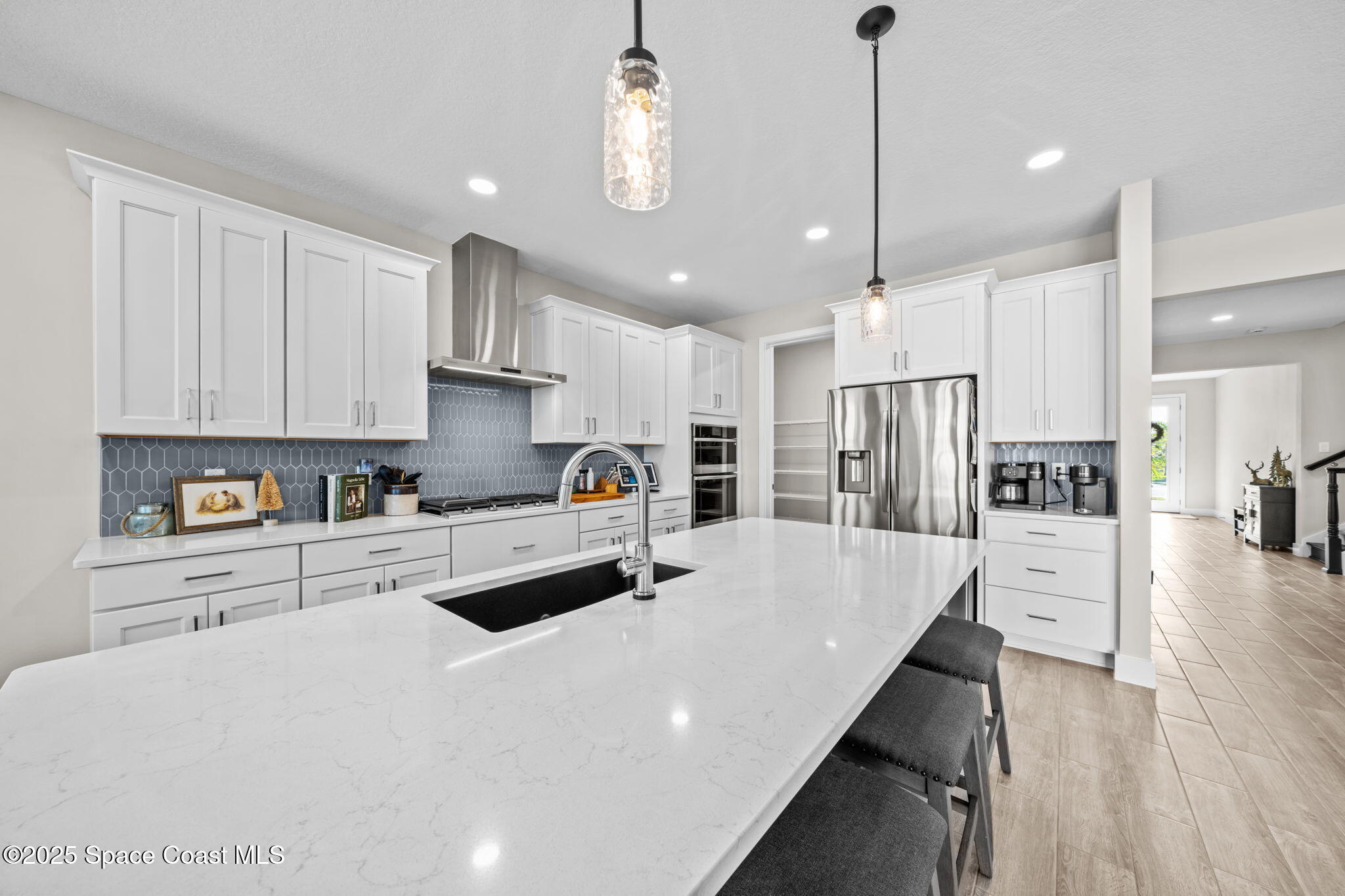 2846 Silverlefe Lane Melbourne, FL 32940 - Photo 5 of 58 a kitchen with stainless steel appliances a refrigerator sink and cabinets